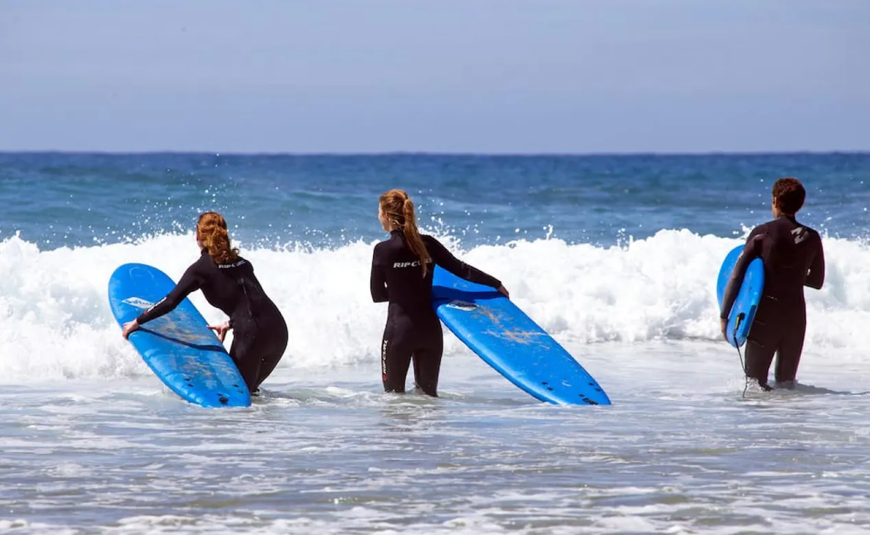 Beginner surfers with soft boards in the whitewater near Rancho Santana, Nicaragua
