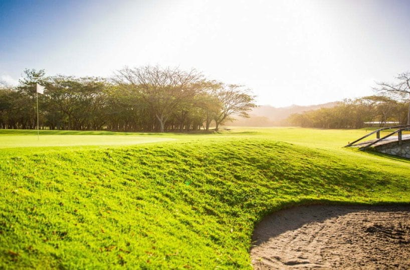 Green fairway and bunker on the golf course at Hacienda Iguana, Tola, Nicaragua