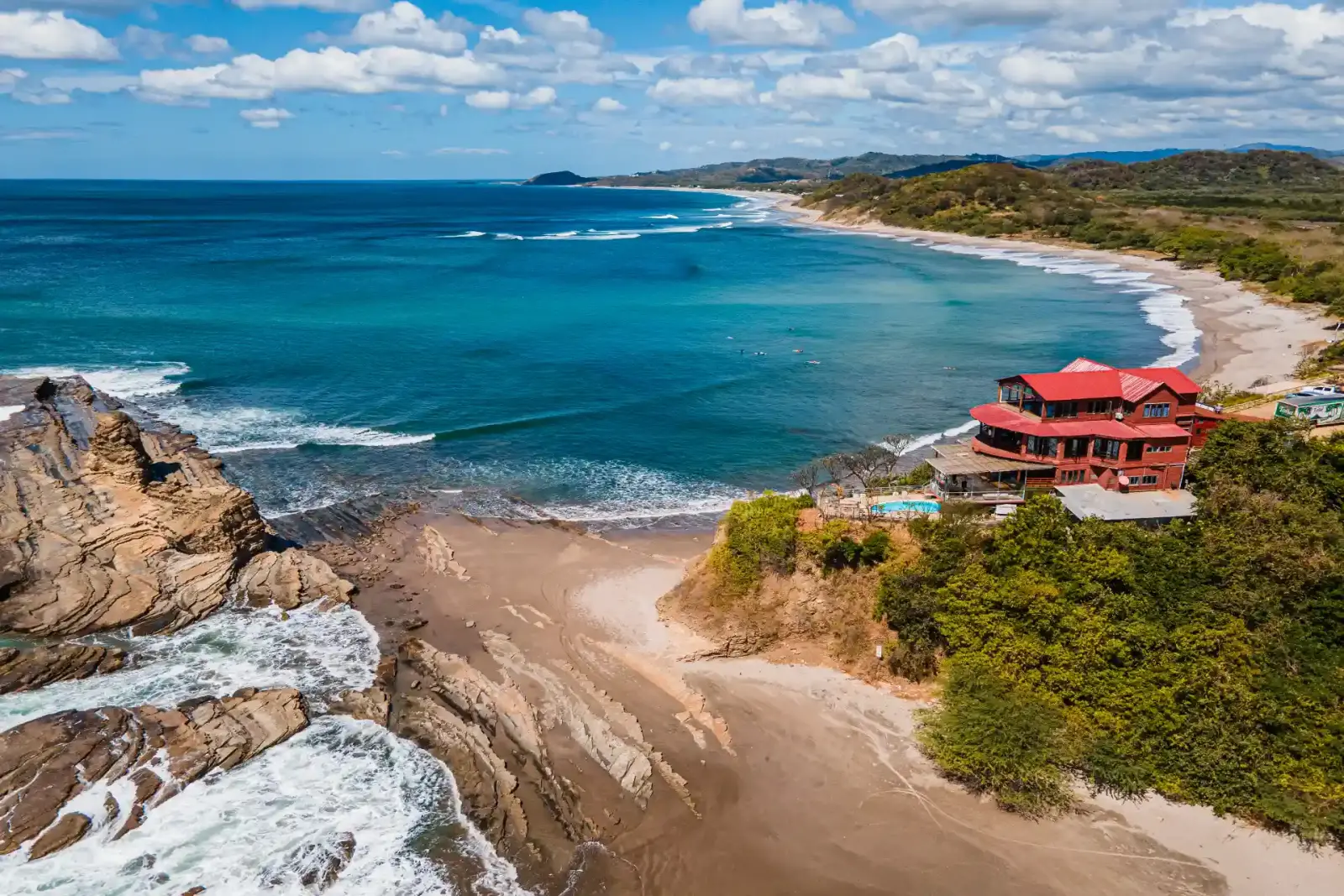 Aerial view of Beginners Bay in Popoyo, Nicaragua, with the rocky headland, beach and coastline