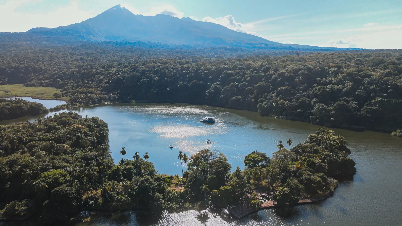 Aerial view of Mombacho Volcano rising above forest and Lake Nicaragua near Granada