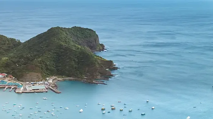The bay of San Juan del Sur, Nicaragua, with sailboats, the town beach and green hills